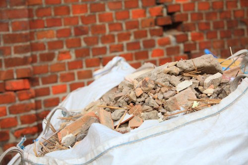 Construction site in Maida Vale with workers clearing waste